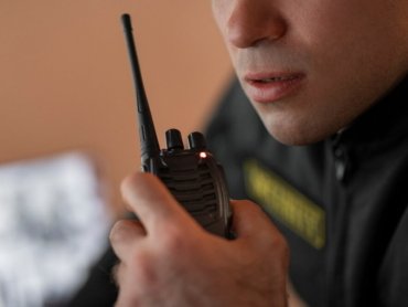 portrait-male-security-guard-with-radio-station-camera-screens_23-2150368720