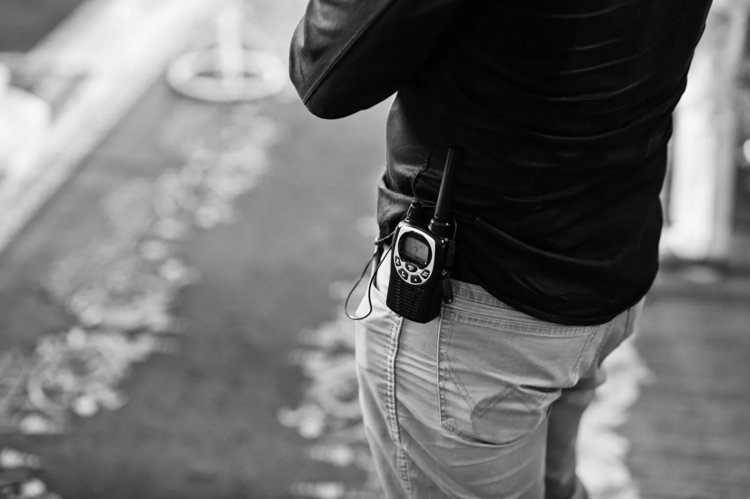 Professional walkie-talkie radio in belt of security man.